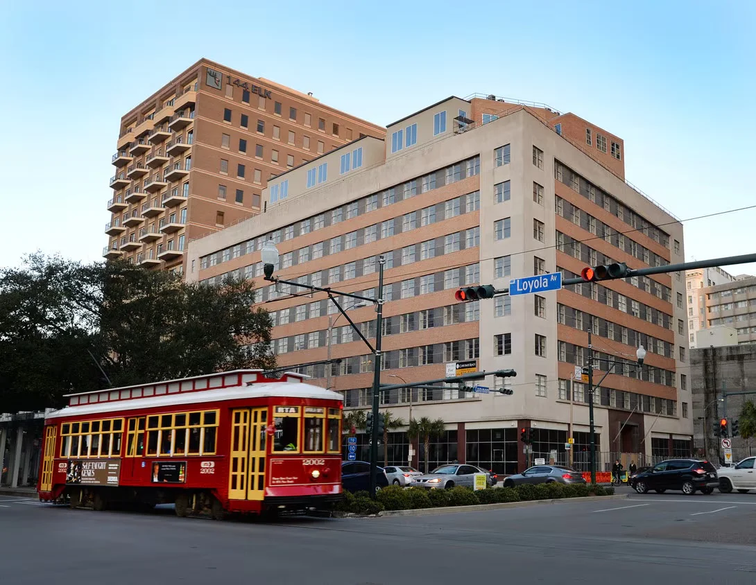 A New Orleans streetcar passing the California Building, home of Carpe Viam Destinations